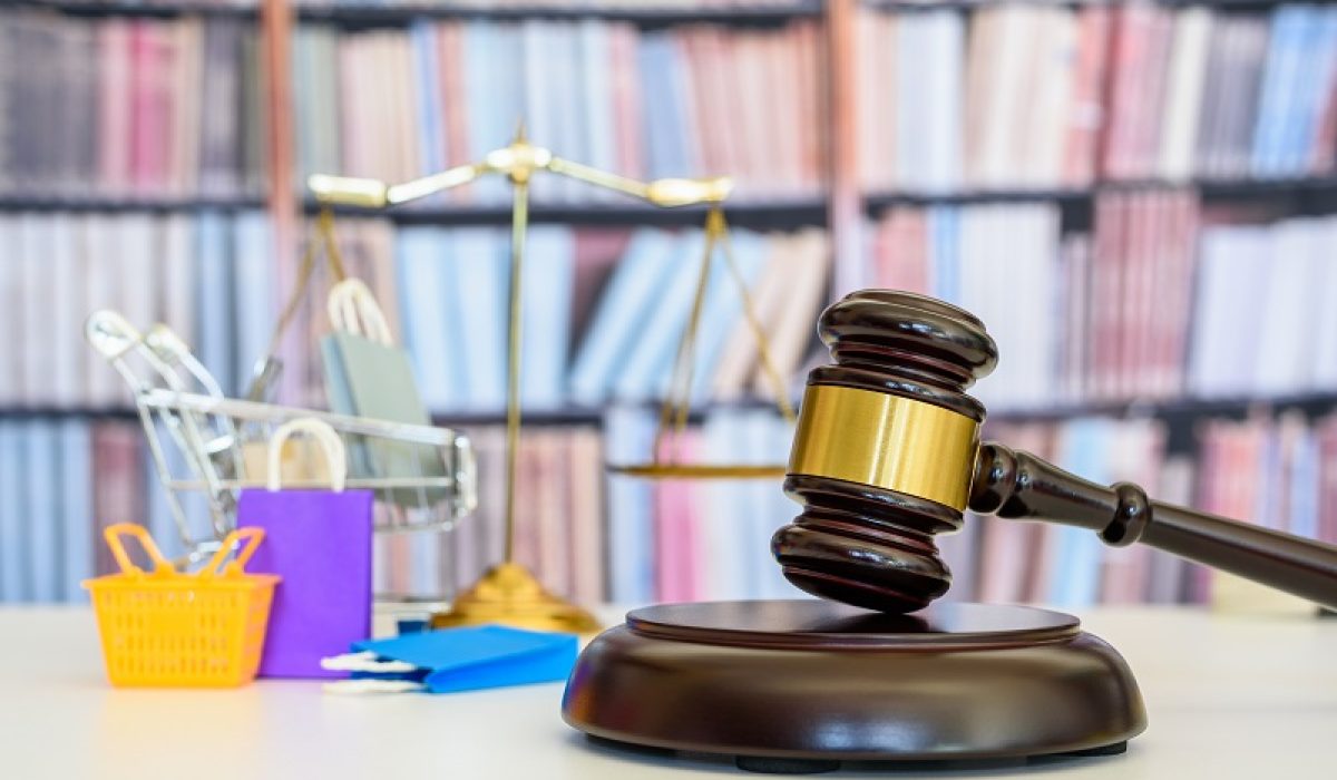 Consumer protection law, rights and guarantees, justice concept : Judge gavel, balance scale, bags, a shopping cart, depicting a safeguard designed to protect buyers from fraudulent business practices.