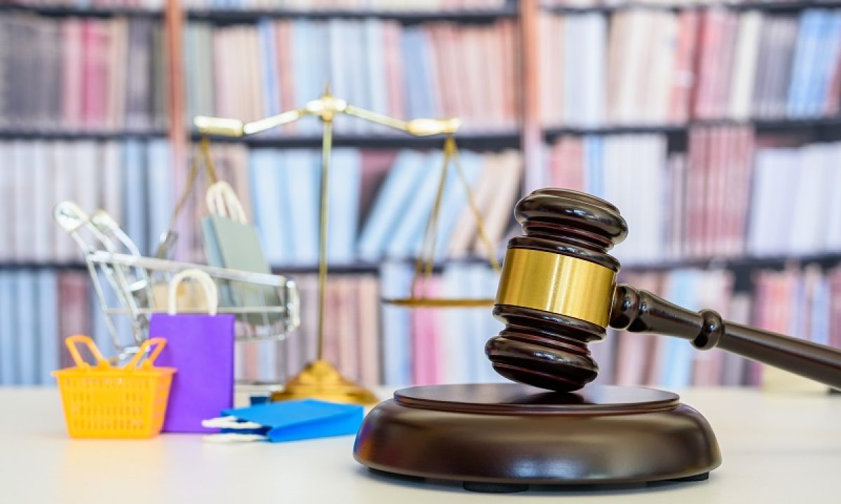 Consumer protection law, rights and guarantees, justice concept : Judge gavel, balance scale, bags, a shopping cart, depicting a safeguard designed to protect buyers from fraudulent business practices.